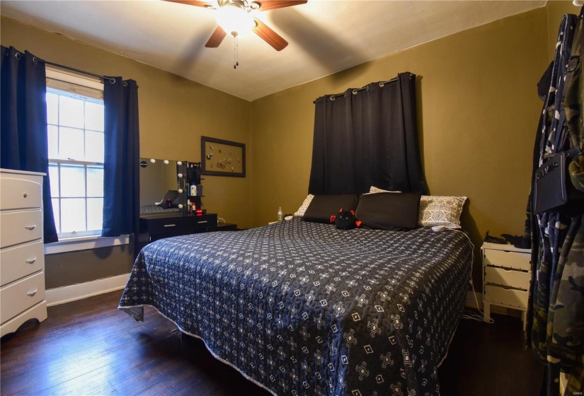 Bedroom with dark hardwood / wood-style flooring and ceiling fan