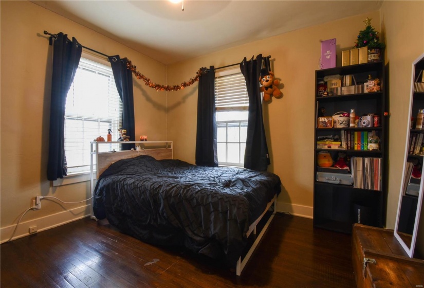 Bedroom with dark wood-type flooring