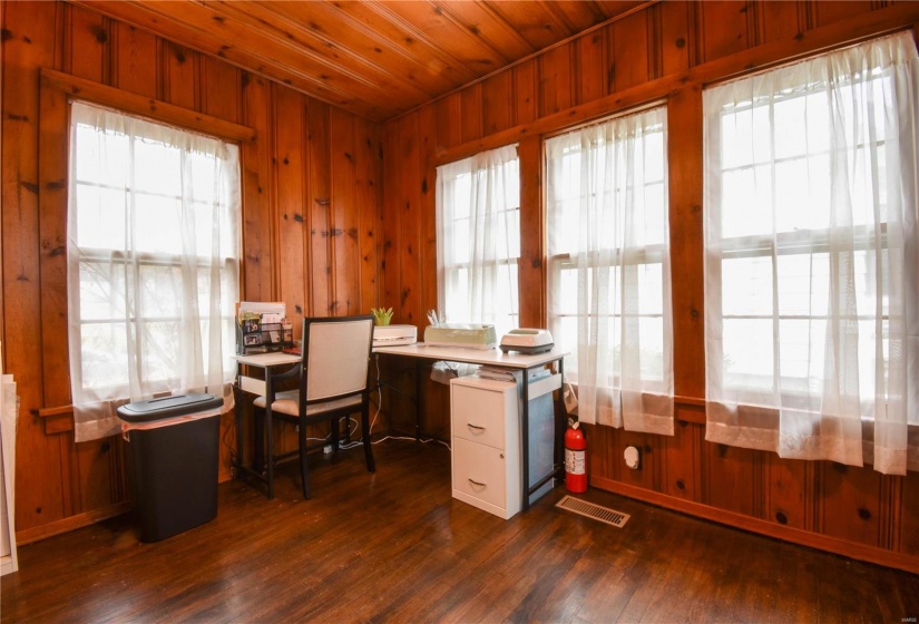 Office featuring wood walls, dark wood-type flooring, and wooden ceiling