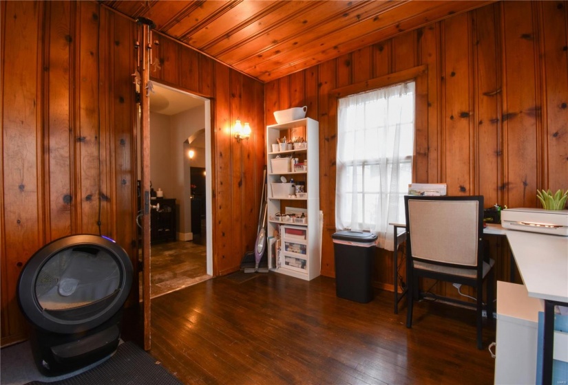 Office area featuring wooden walls, wooden ceiling, and dark hardwood / wood-style floors