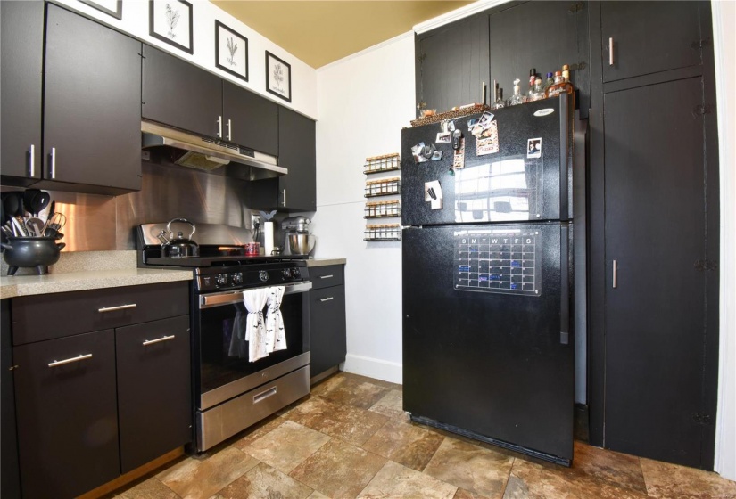 Kitchen featuring gas range and black fridge